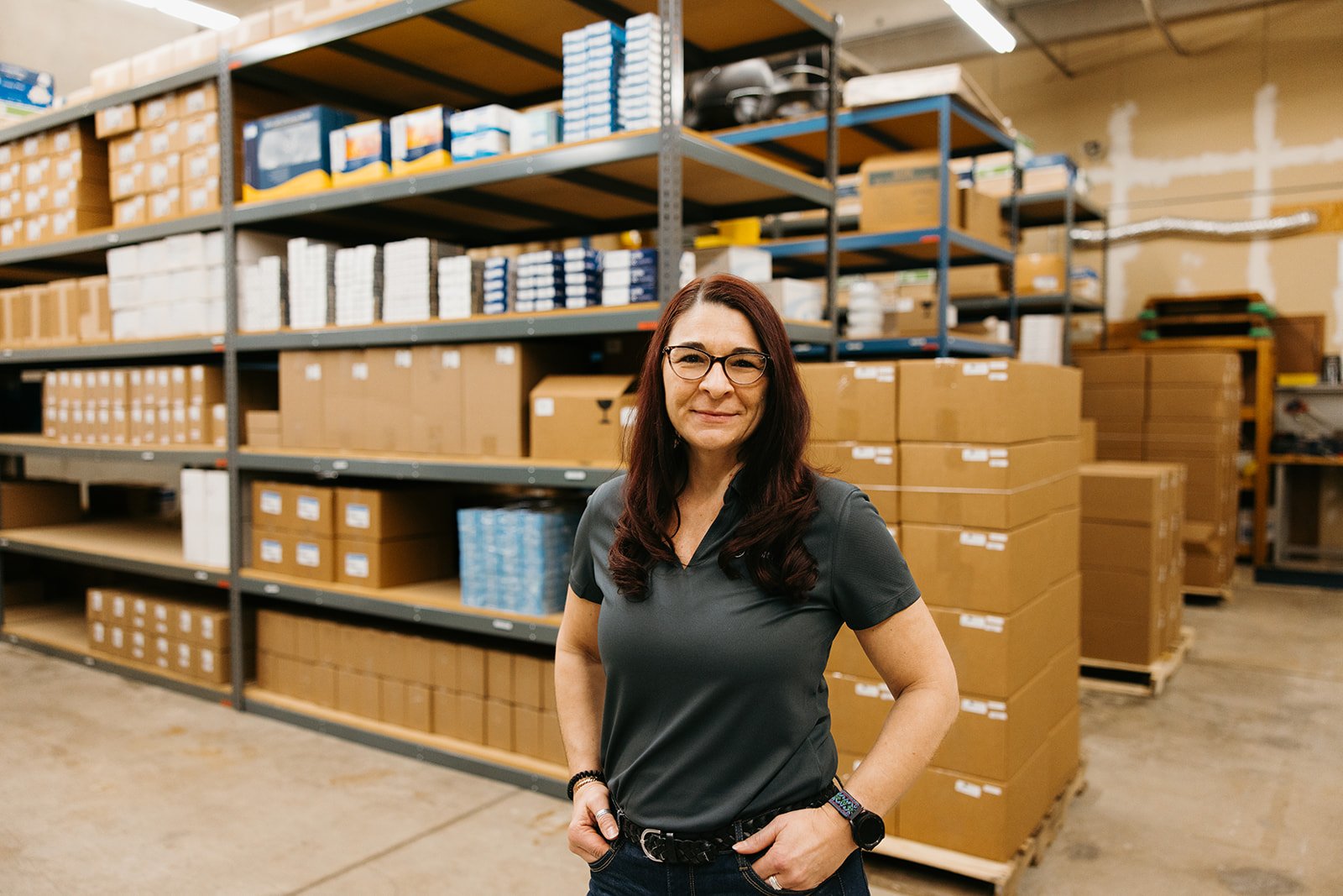 Director Of Customer Experience in front of stock in warehouse